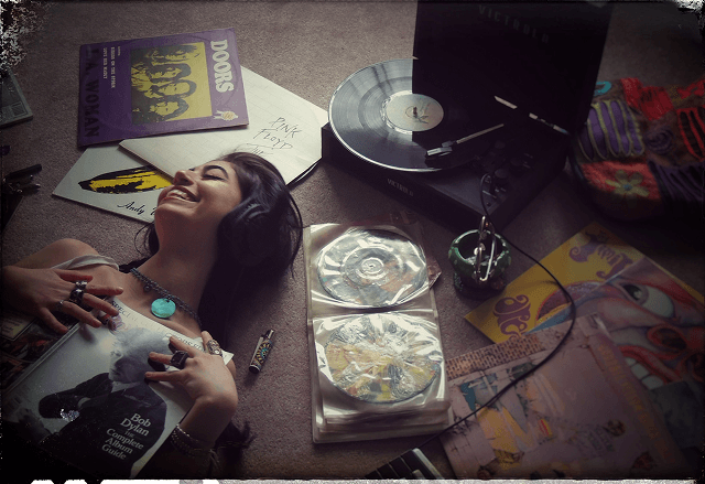Neta listening to music among vinyl records